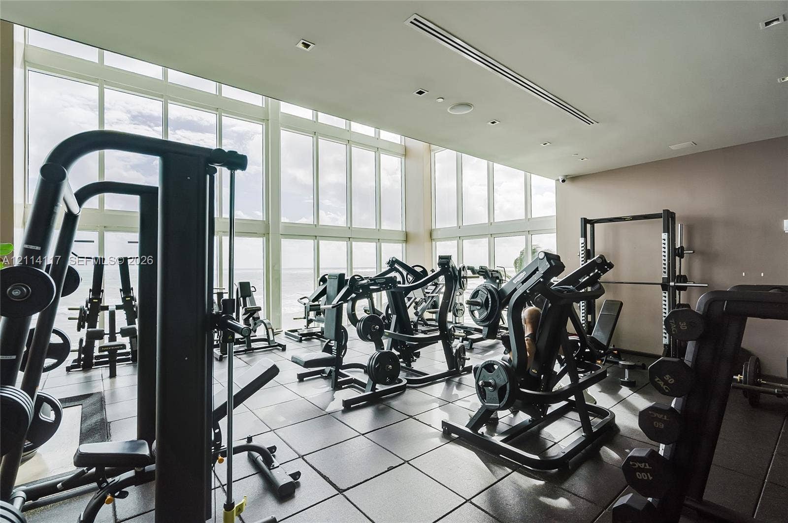 1850 S Ocean Drive, #4008, Hallandale Beach, Hallandale Beach, FL 33009 Fitness center featuring floor-to-ceiling windows, natural lighting, and modular tile flooring