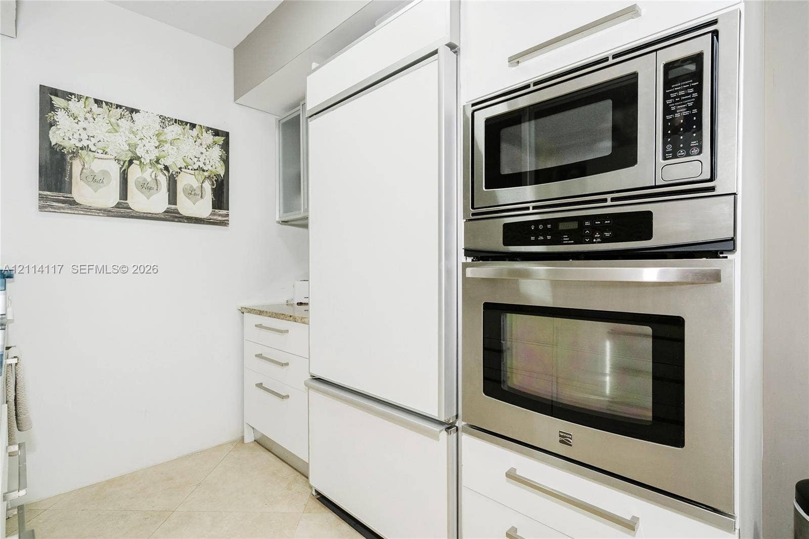 1850 S Ocean Drive, #4008, Hallandale Beach, Hallandale Beach, FL 33009 Stainless steel built-in microwave and wall oven, integrated panel-ready refrigerator, white shaker-style cabinetry with satin nickel hardware, and stone-finish countertops