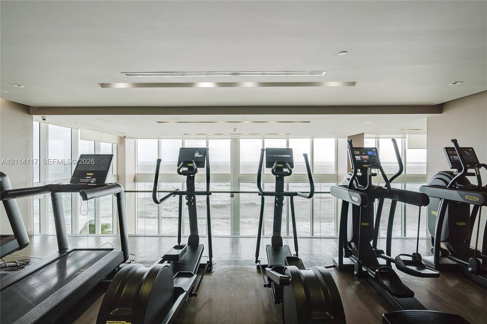 1850 S Ocean Drive, #4008, Hallandale Beach, Hallandale Beach, FL 33009 Fitness room featuring floor-to-ceiling windows and wood-finish flooring