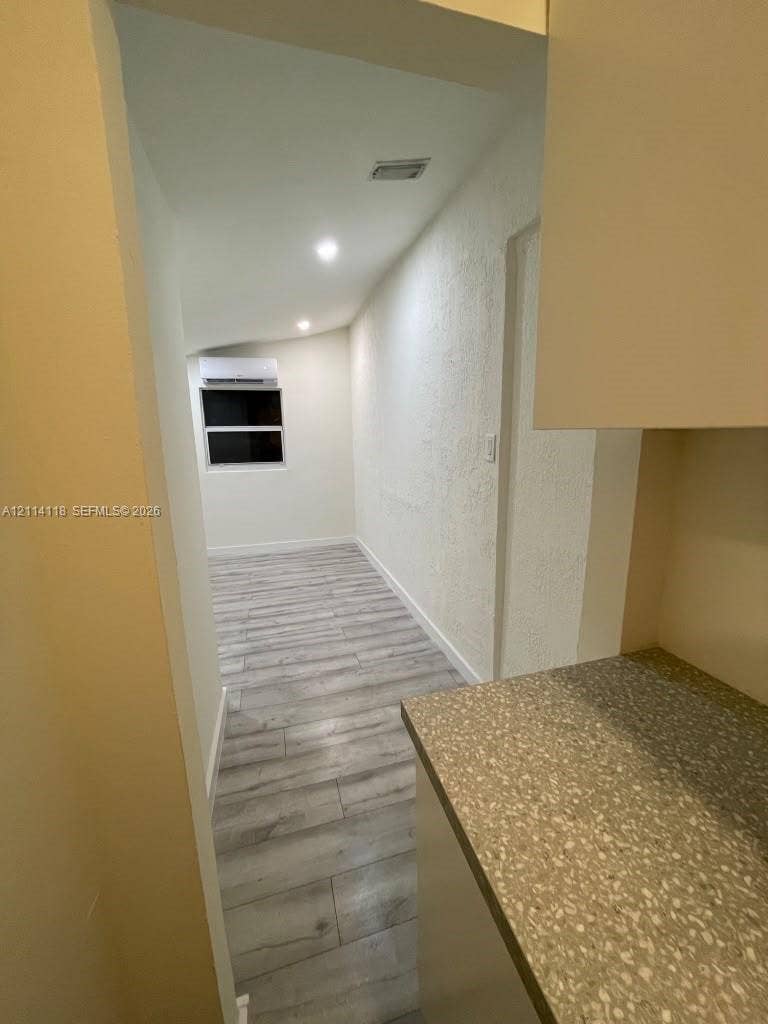 2484 SW 10th Street, #4 - eff, Miami, Miami, FL 33135 Wood-finish flooring, textured wall surfaces, recessed lighting, and wall-mounted ductless climate control unit