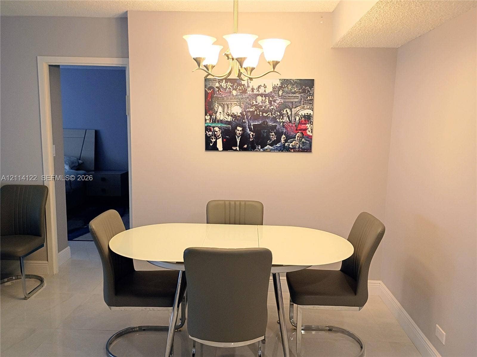 251 174th Street, #1208, Sunny Isles Beach, Sunny Isles Beach, FL 33160 Dining area featuring light-toned tile flooring and a multi-arm chandelier with frosted glass shades