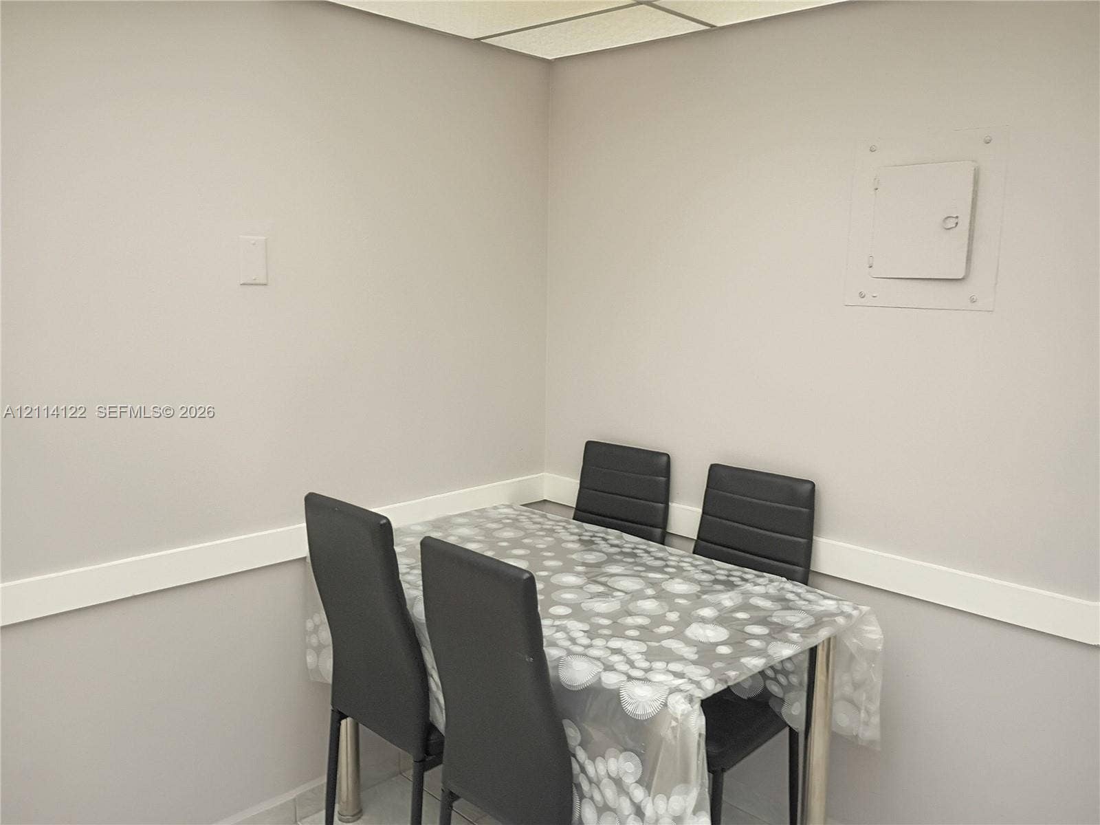 251 174th Street, #1208, Sunny Isles Beach, Sunny Isles Beach, FL 33160 Neutral-toned interior space featuring light-colored wall finish, linear wall molding, and recessed ceiling grid panel