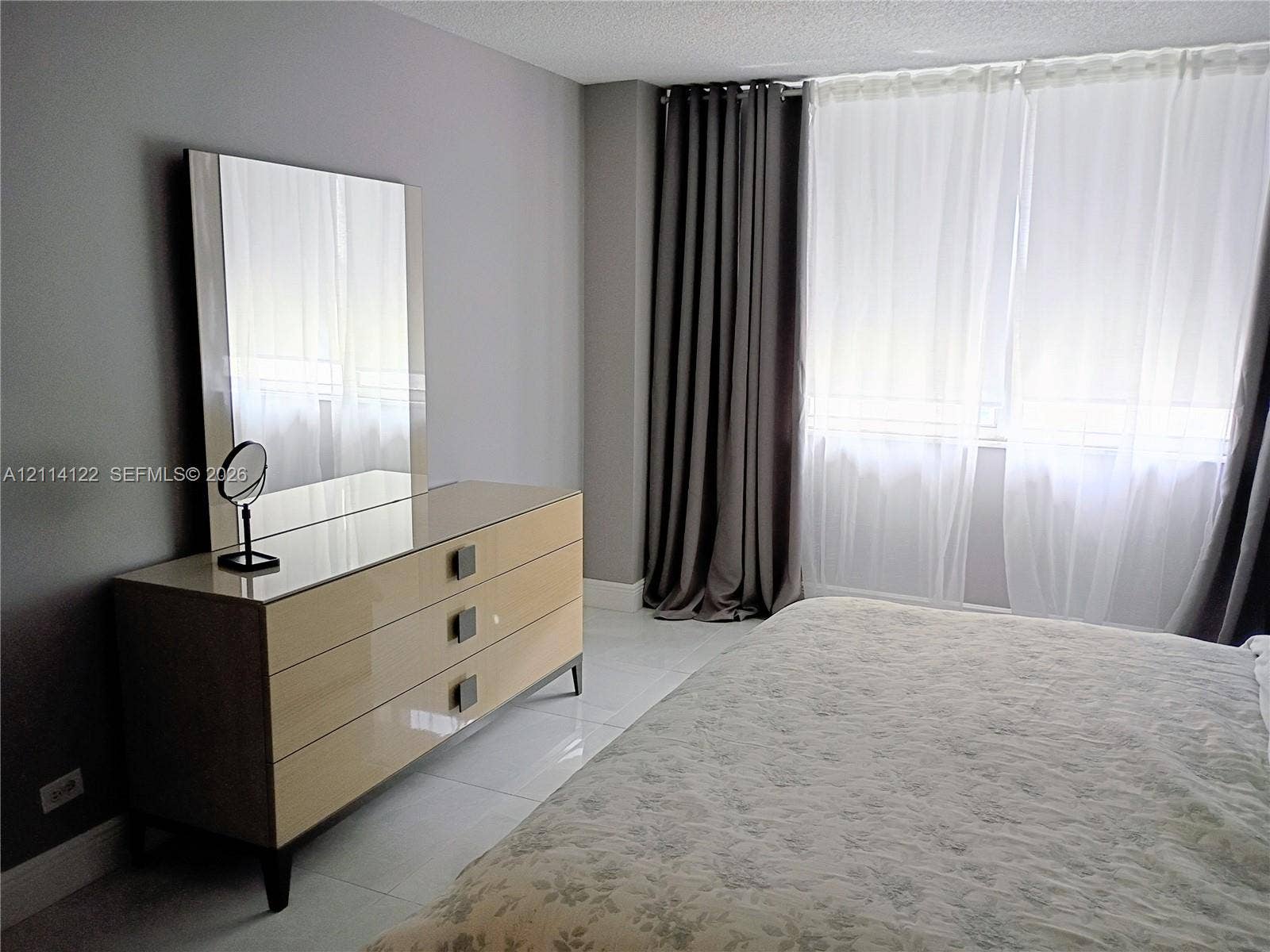 251 174th Street, #1208, Sunny Isles Beach, Sunny Isles Beach, FL 33160 Neutral-toned wall finish, large-format tile flooring, and floor-to-ceiling window treatments