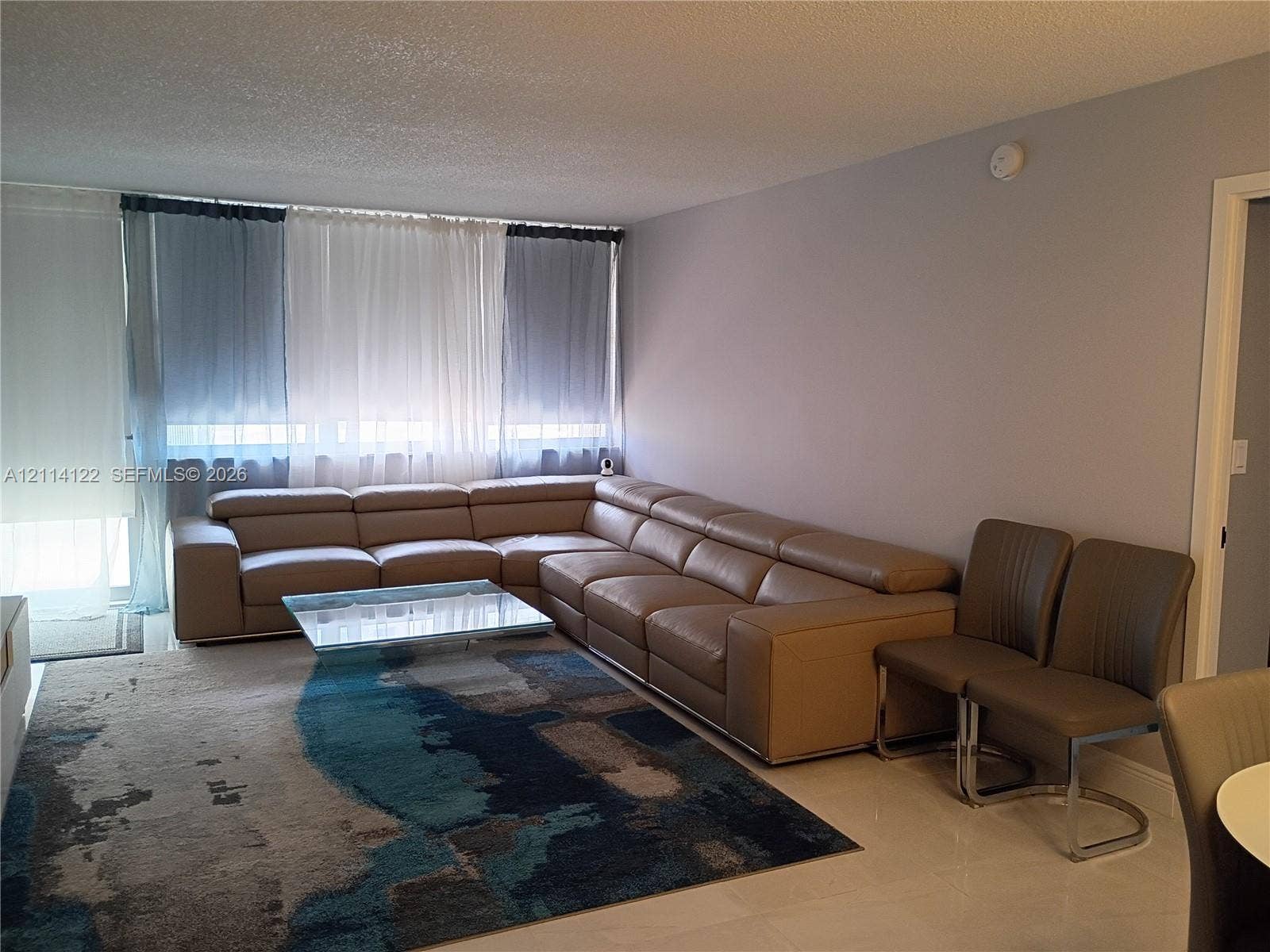 251 174th Street, #1208, Sunny Isles Beach, Sunny Isles Beach, FL 33160 Open-concept living area featuring floor-to-ceiling windows and neutral-tone tile flooring