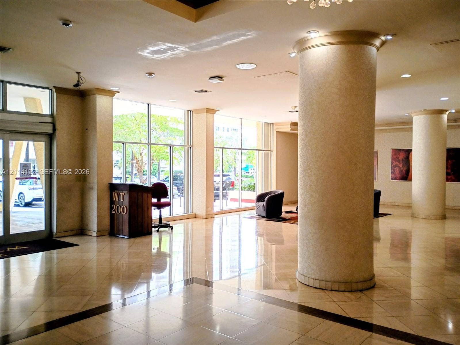 251 174th Street, #1208, Sunny Isles Beach, Sunny Isles Beach, FL 33160 Lobby featuring floor-to-ceiling windows, polished stone tile flooring, structural columns, and recessed lighting