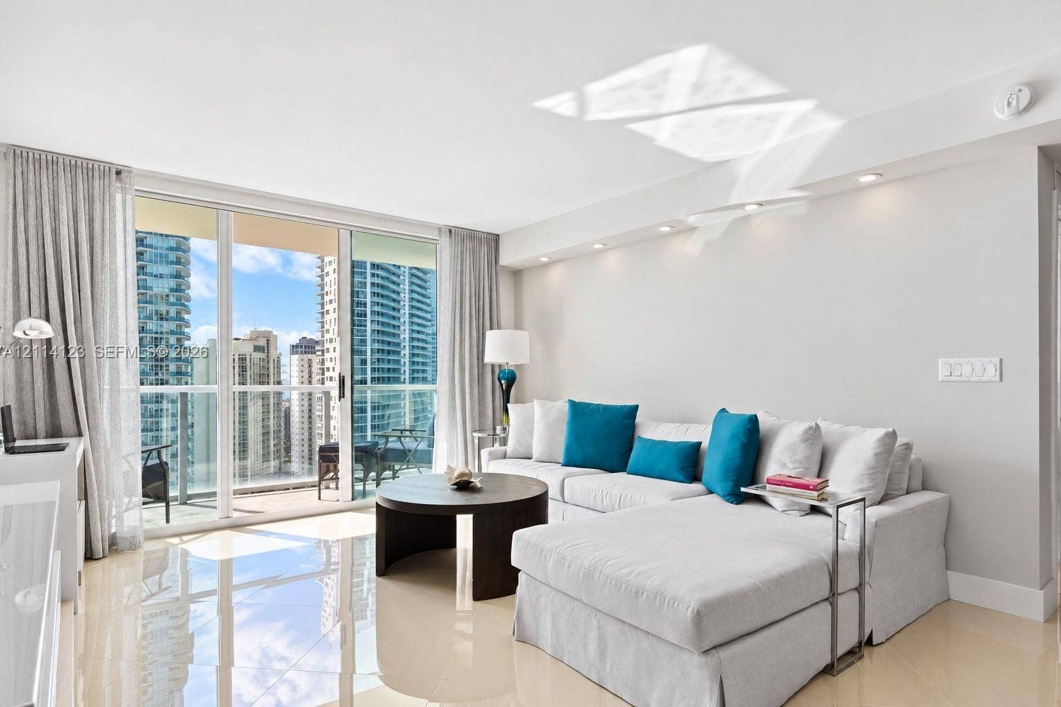 1155 Brickell Bay Drive, #2609, Miami, FL 33131 Floor-to-ceiling sliding glass doors, private balcony, polished tile flooring, and recessed ceiling lighting