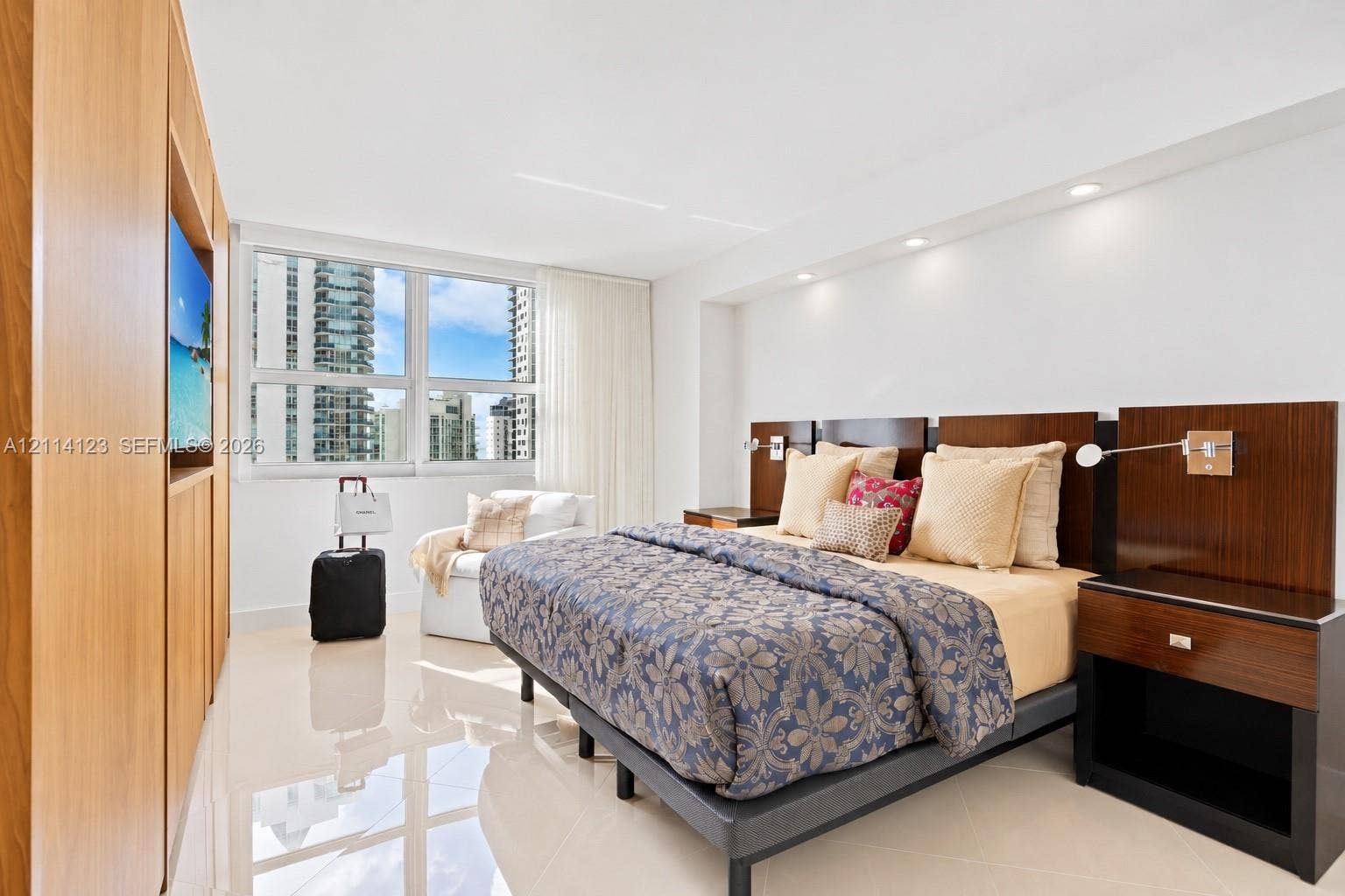1155 Brickell Bay Drive, #2609, Miami, FL 33131 Polished tile flooring, custom wood-finish built-in cabinetry, integrated recessed lighting, and wall-mounted reading lights