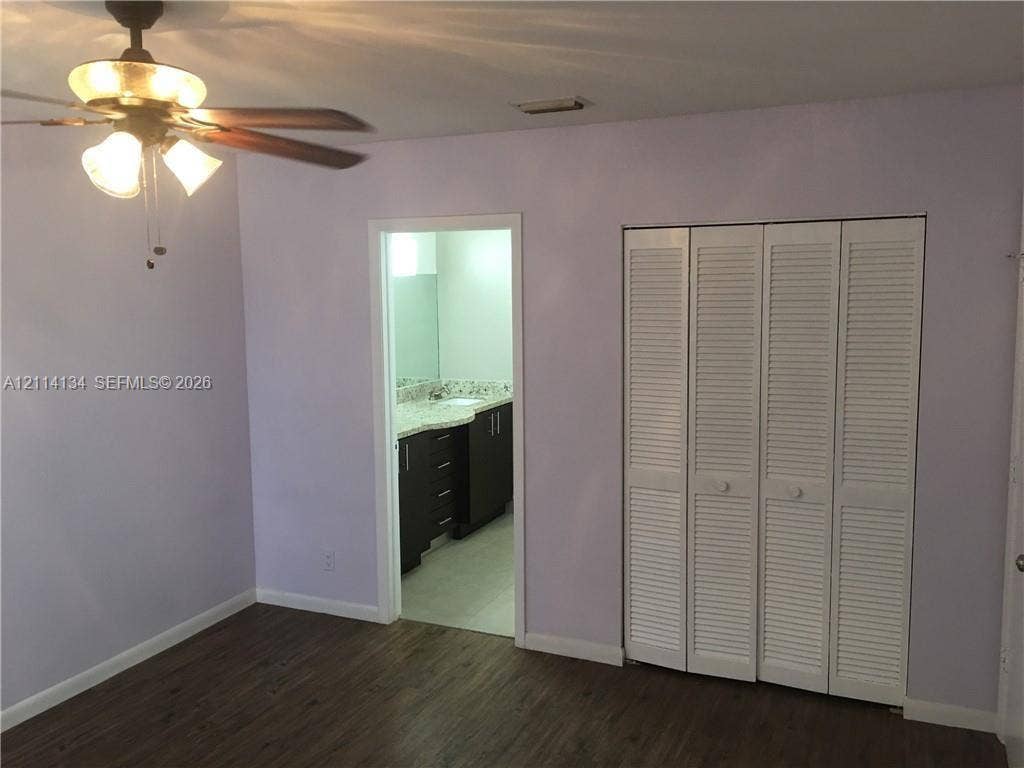 12143 Royal Palm Boulevard, #8E, Coral Springs, Coral Springs, FL 33065 Wood-finish flooring, ceiling fan with integrated lighting, and closet with white louvered bifold doors