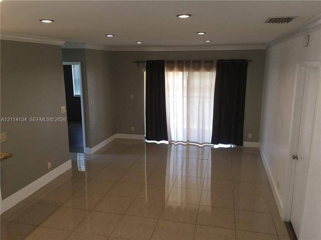 12143 Royal Palm Boulevard, #8E, Coral Springs, Coral Springs, FL 33065 Living area featuring large-format tile flooring, recessed lighting, and crown molding