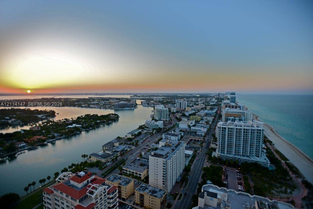6365 Collins Avenue, #3908, Miami Beach, FL 33141 High-altitude coastal panorama featuring an expansive shoreline, an inlet waterway, and sunset horizon