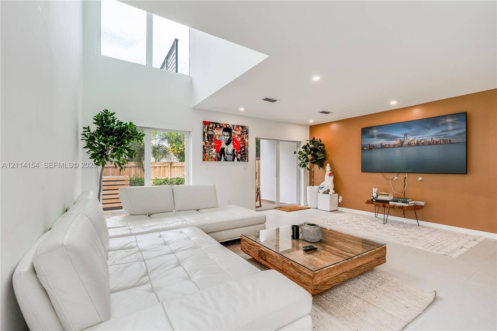 1126 NE 2nd Avenue, Fort Lauderdale, FL 33304 High-ceiling living area featuring double-height windows, recessed lighting, and large-format tile flooring