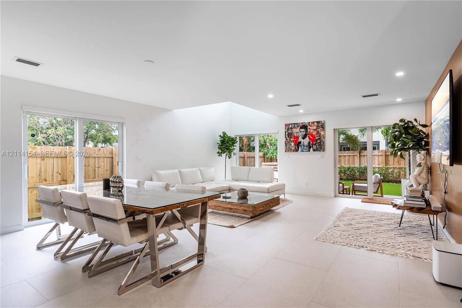 1126 NE 2nd Avenue, Fort Lauderdale, FL 33304 Open-concept room featuring light-toned tile flooring, recessed ceiling lighting, a large skylight, and dual sliding glass doors