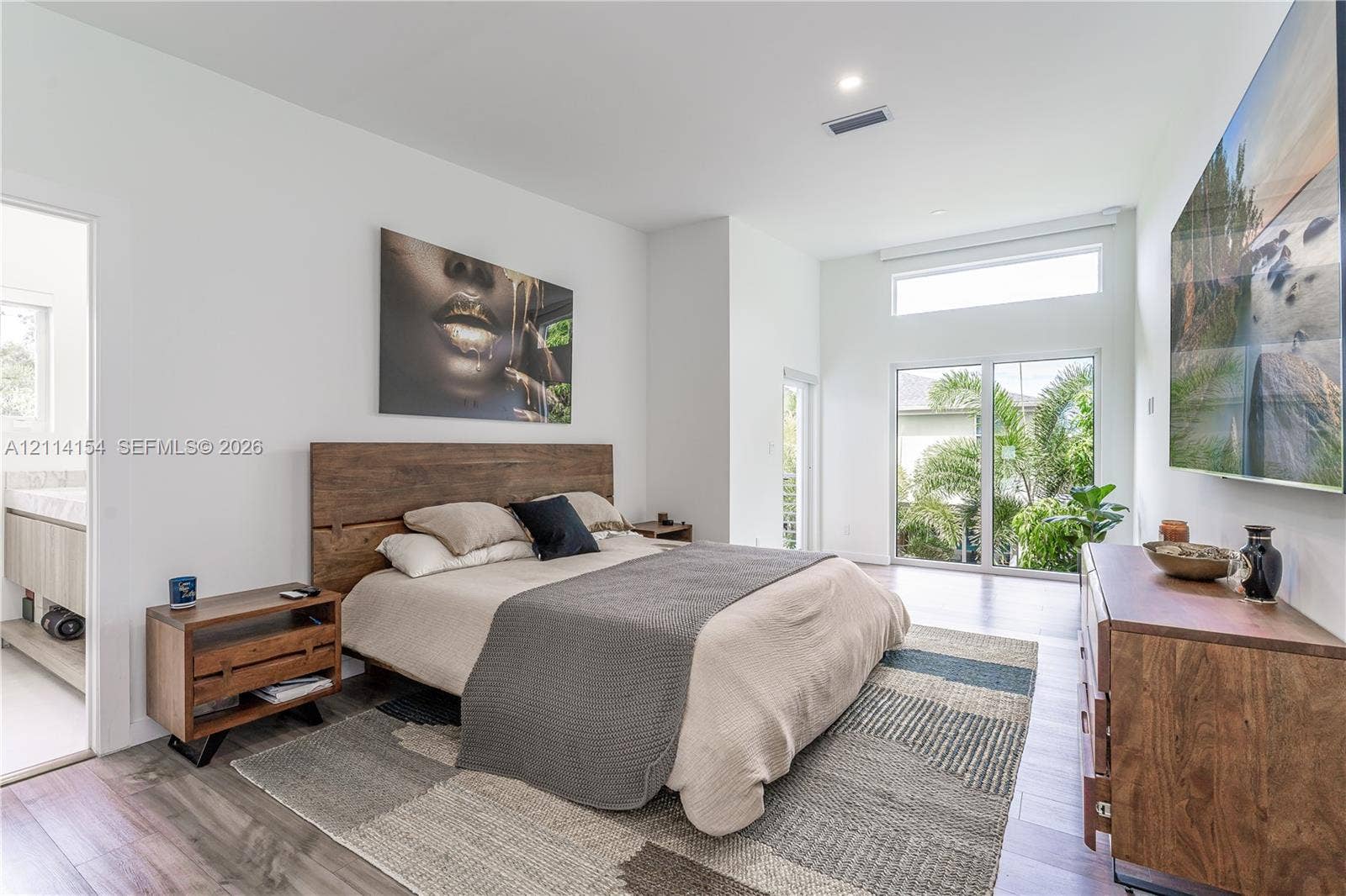 1126 NE 2nd Avenue, Fort Lauderdale, FL 33304 High ceilings with transom window, wood-finish flooring, and large sliding glass doors