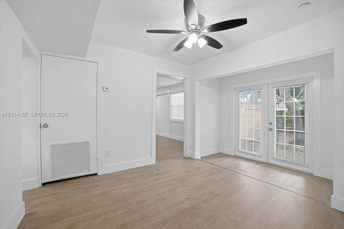 2580 NW 62nd Avenue, Margate, FL 33063 Interior space featuring wood-finish flooring, white walls, and a ceiling fan with integrated lighting
