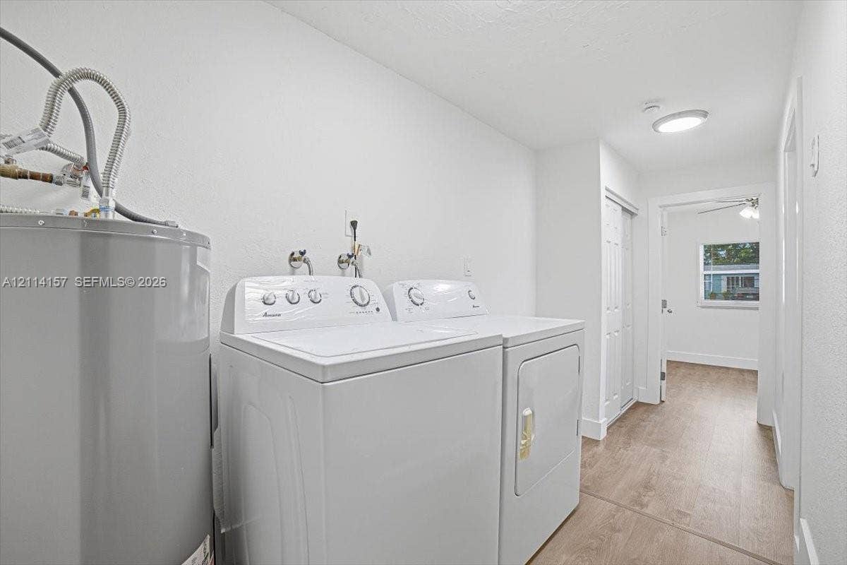 2580 NW 62nd Avenue, Margate, FL 33063 Laundry space featuring wood-finish flooring, ceiling-mounted lighting, and double-door closet storage