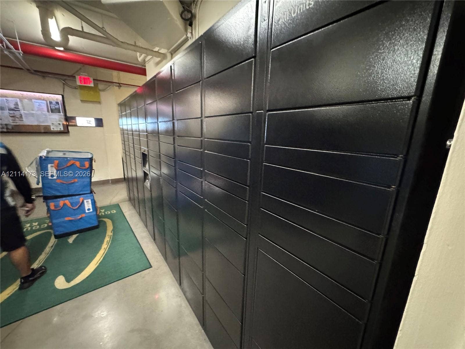 701 Brickell Key Boulevard, #1012, Miami, FL 33131 Secure metal parcel storage lockers featuring a matte black finish and integrated electronic kiosk interface