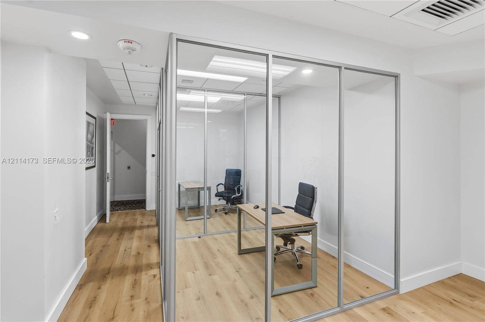 701 Brickell Key Boulevard, #1012, Miami, FL 33131 Enclosed office space featuring glass-panel walls, aluminum framing, recessed lighting, and wood-finish flooring