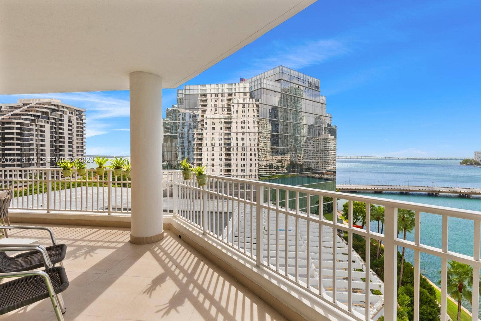 701 Brickell Key Boulevard, #1012, Miami, FL 33131 Covered balcony featuring tile flooring, a support column, and white metal railings with nautical and cityscape scenery