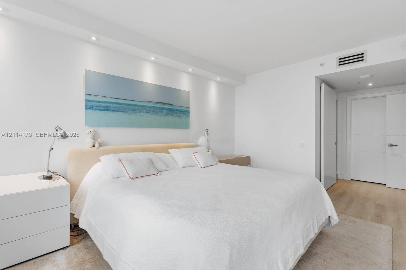 701 Brickell Key Boulevard, #1012, Miami, FL 33131 Neutral-toned wood-finish flooring, recessed ceiling lighting, and solid-core interior doors