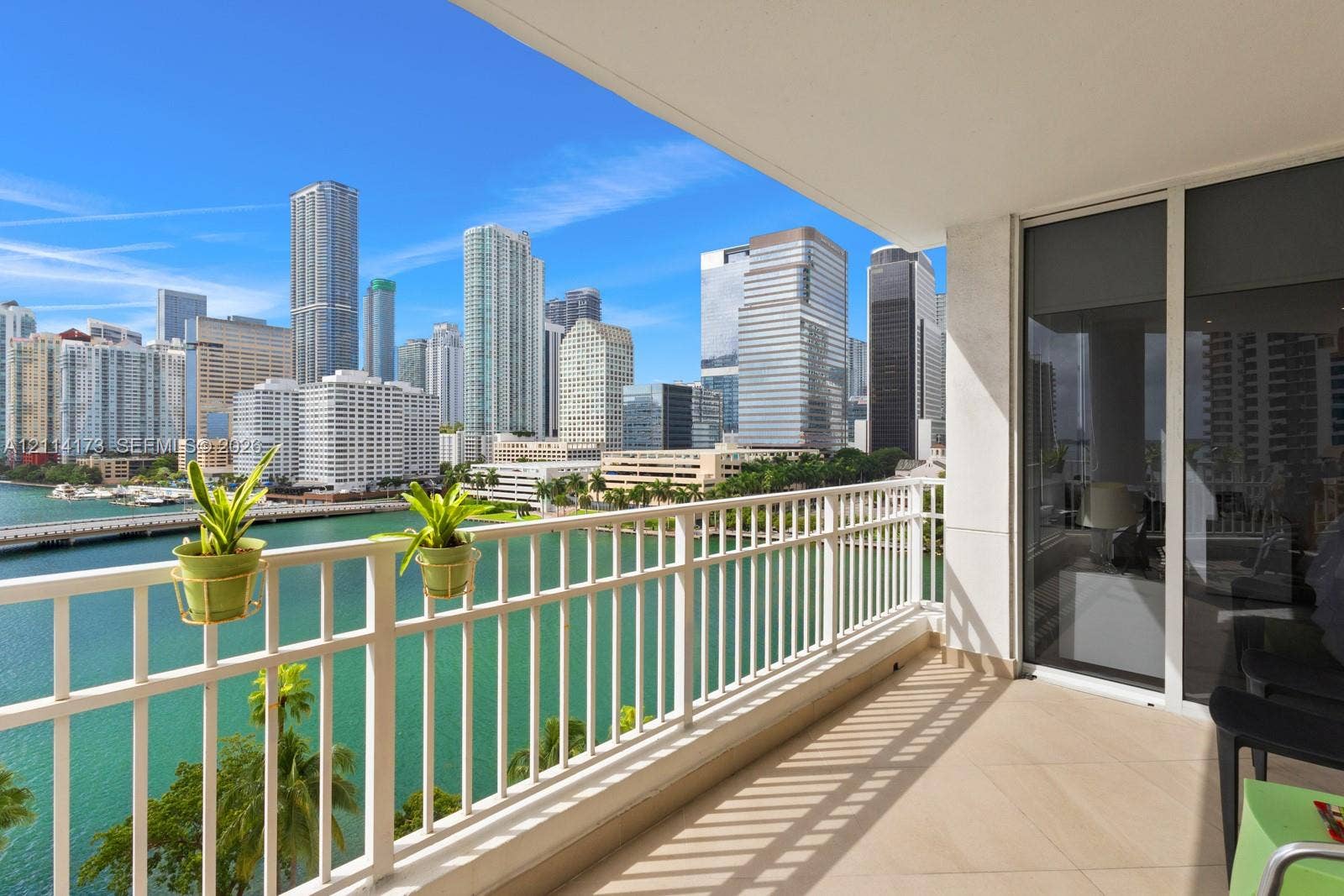 701 Brickell Key Boulevard, #1012, Miami, FL 33131 Private balcony featuring ceramic tile flooring, a white metal railing, and floor-to-ceiling glass sliding doors