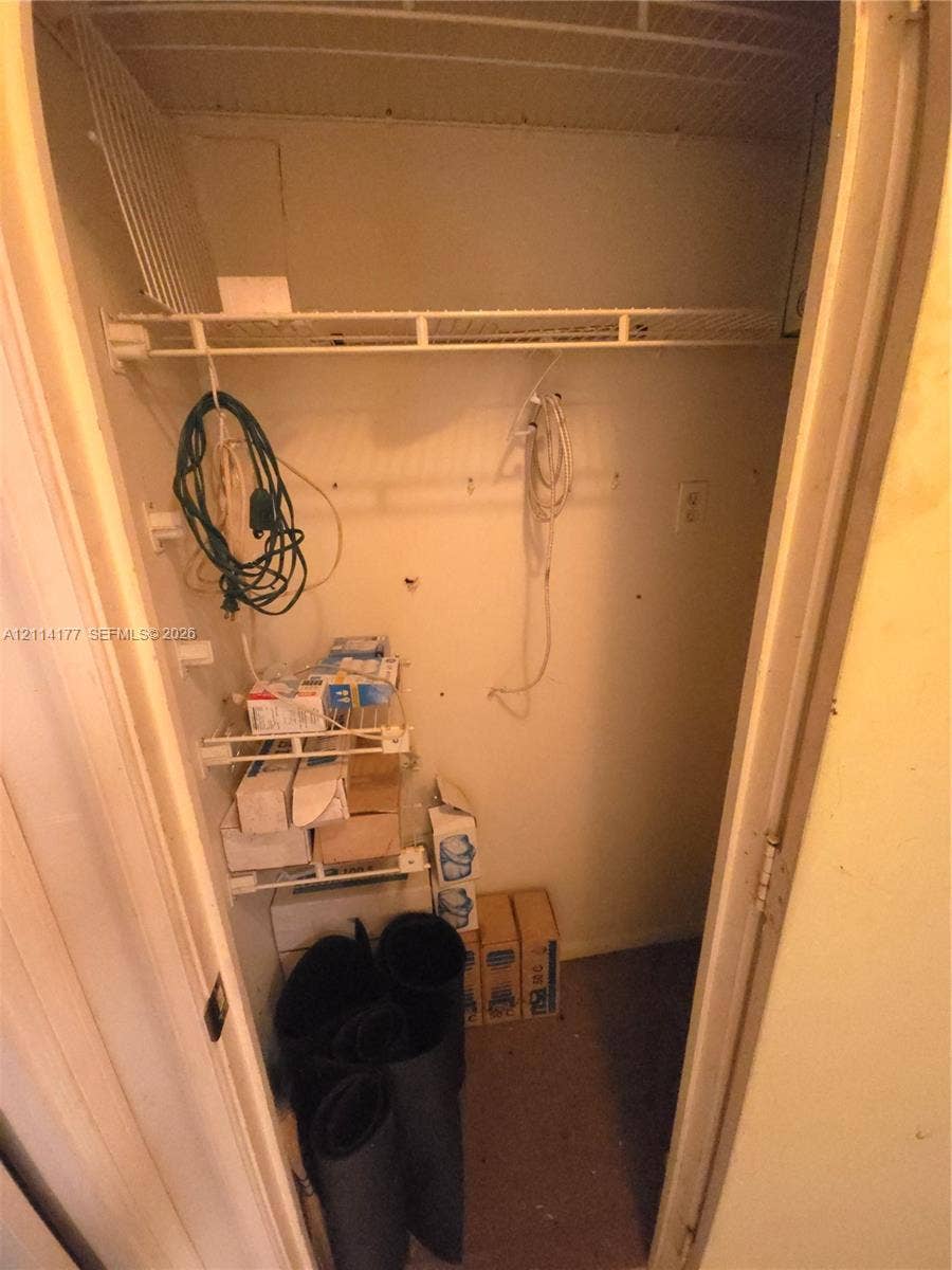 1731 SE 15th Street, #403, Fort Lauderdale, FL 33316 Storage closet featuring wire shelving and a hanging rod