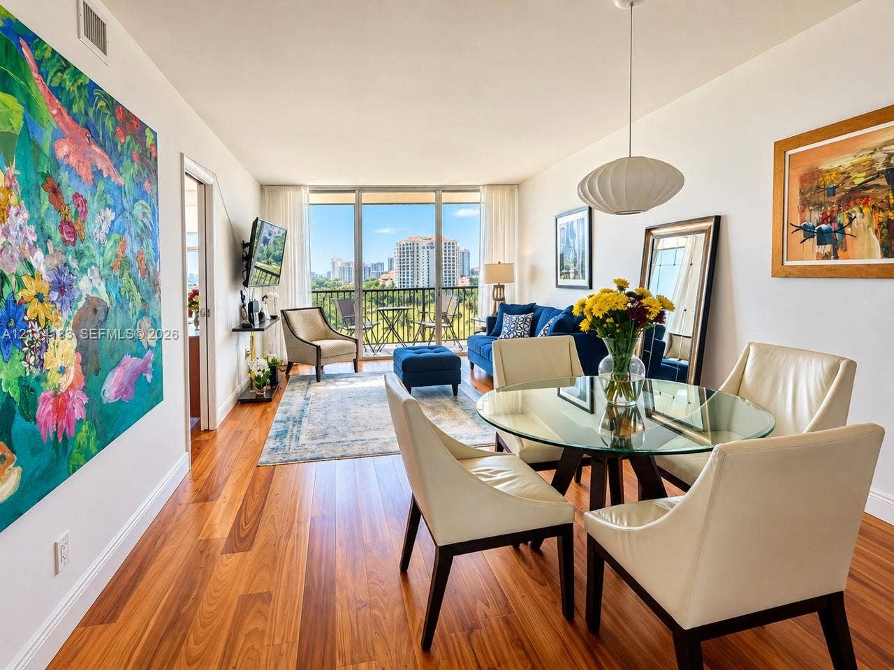 20379 W Country Club Drive, #938, Aventura, FL 33180 Open-concept interior featuring wood-finish flooring, floor-to-ceiling windows, and a private balcony