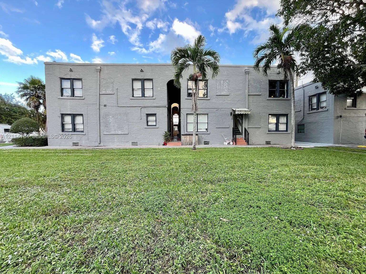 1614 Harrison Street, #1B, Hollywood, Hollywood, FL 33020 Multi-story masonry exterior with central arched entryway and expansive lawn