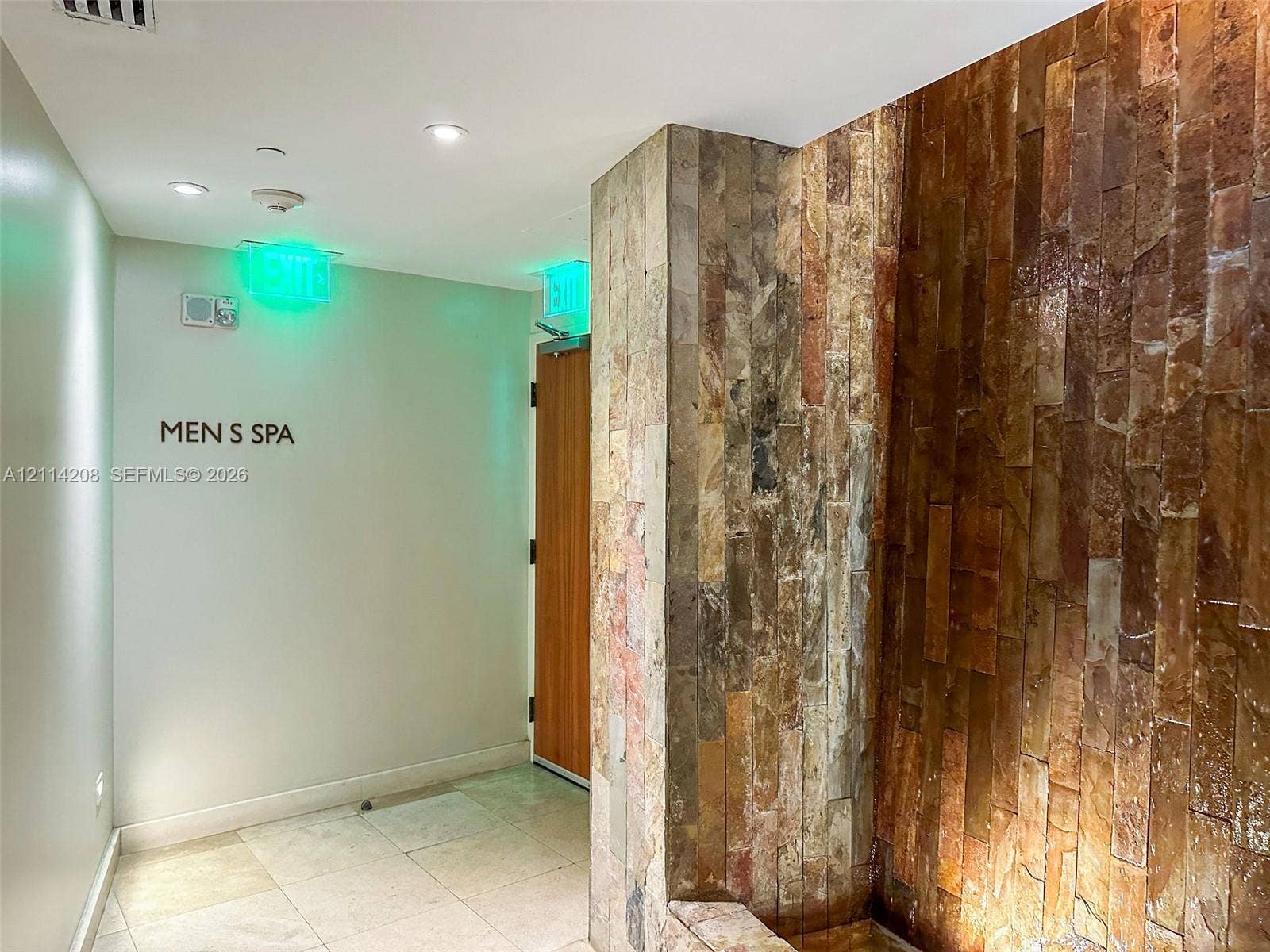 6801 Collins Avenue, #604, Miami Beach, FL 33141 Floor-to-ceiling stone-clad wall accent, recessed ceiling lighting, and tile flooring