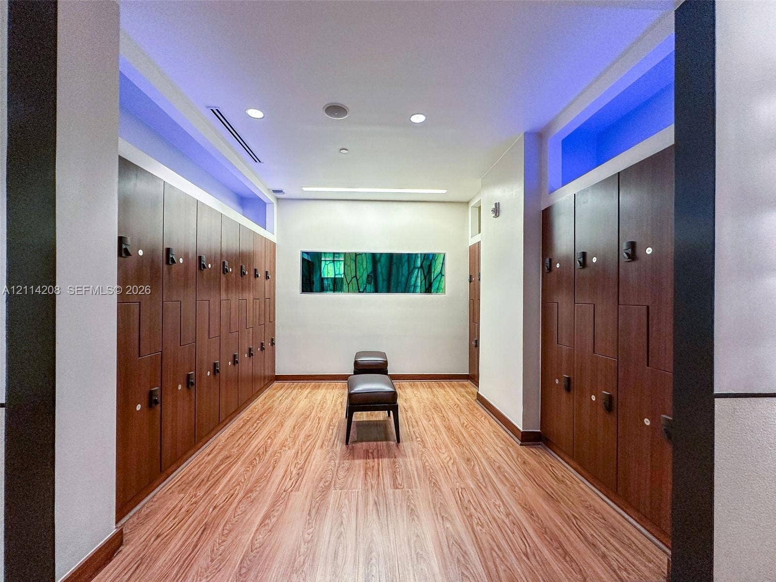 6801 Collins Avenue, #604, Miami Beach, FL 33141 Rows of full-height wood-finish storage lockers, wood-finish flooring, recessed ceiling lighting, and a horizontal rectangular clerestory window