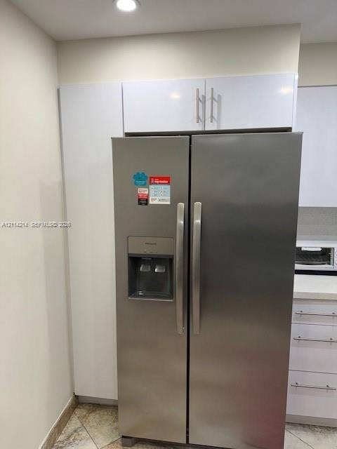 3701 N Country Club Drive, #706, Aventura, FL 33180 Stainless steel side-by-side refrigerator, gloss-finish white cabinetry, and recessed lighting