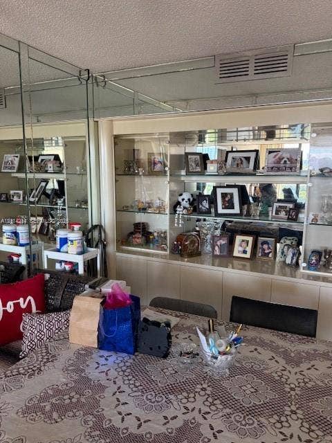 3701 N Country Club Drive, #706, Aventura, FL 33180 Built-in glass-front display cabinetry featuring adjustable shelving, integrated mirror paneling, and base cabinet storage