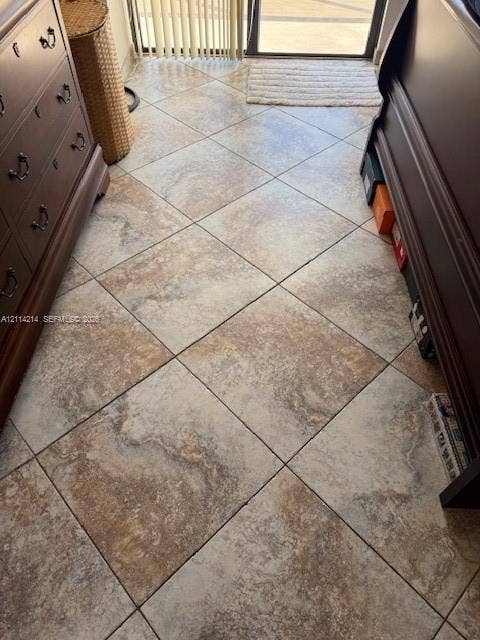 3701 N Country Club Drive, #706, Aventura, FL 33180 Large-format porcelain tile flooring with a neutral, multi-tonal earth tone finish and a diagonal installation pattern