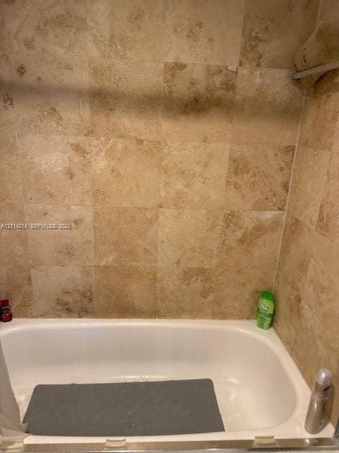 3701 N Country Club Drive, #706, Aventura, FL 33180 Bathtub with white enamel finish and floor-to-ceiling square tile wall surround