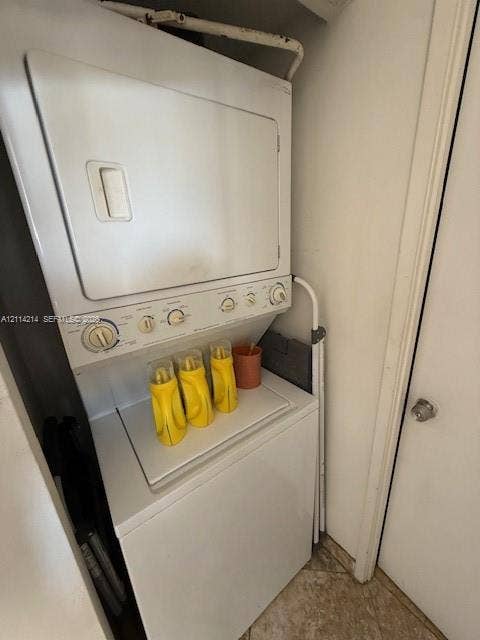 3701 N Country Club Drive, #706, Aventura, FL 33180 Stacked white washer and dryer unit with top-loading machine and manual control knobs