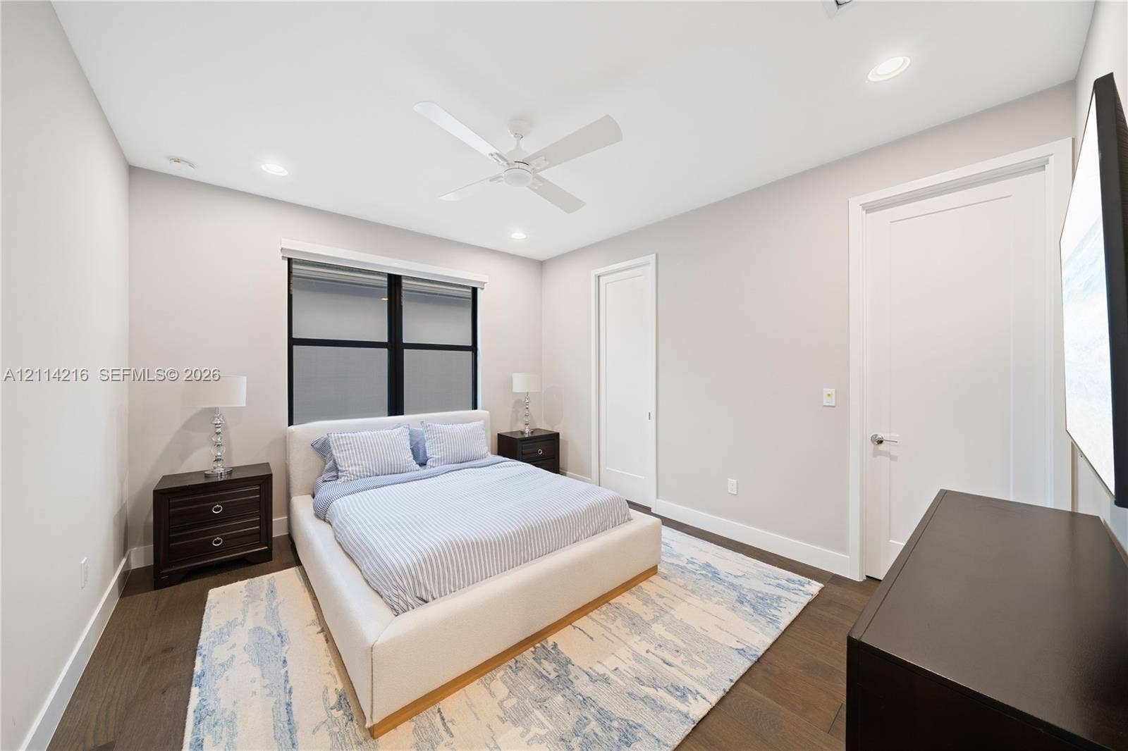 17085 Teton River Road, Boca Raton, FL 33496 Neutral-toned interior room featuring wood-finish flooring, a white ceiling fan, recessed lighting, and a window with black trim
