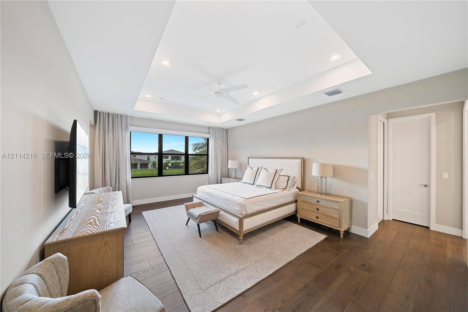 17085 Teton River Road, Boca Raton, FL 33496 Tray ceiling with recessed lighting, wide-plank wood-finish flooring, and black-framed windows