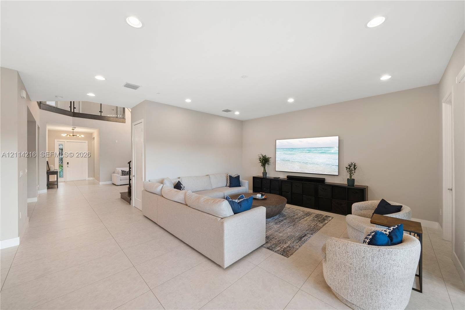 17085 Teton River Road, Boca Raton, FL 33496 Open-concept living space featuring large-format tile flooring, recessed lighting, and a neutral color palette