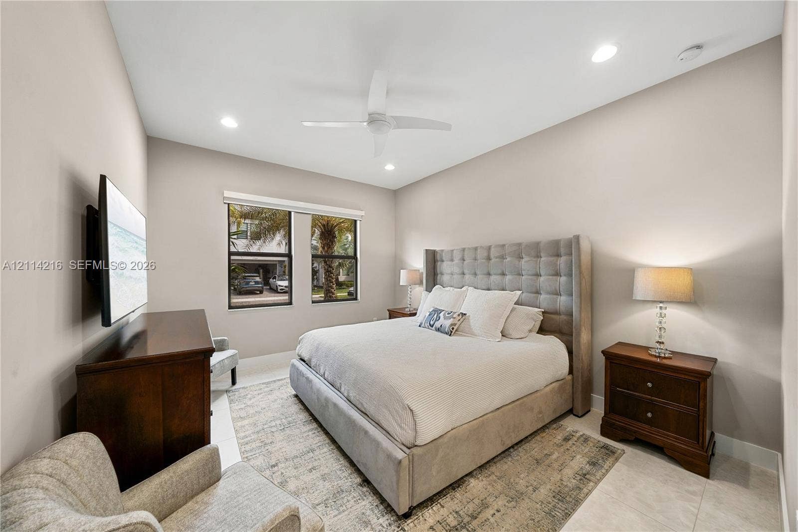 17085 Teton River Road, Boca Raton, FL 33496 Neutral-toned room featuring high ceilings, recessed lighting, a white ceiling fan, and large windows with dark frames