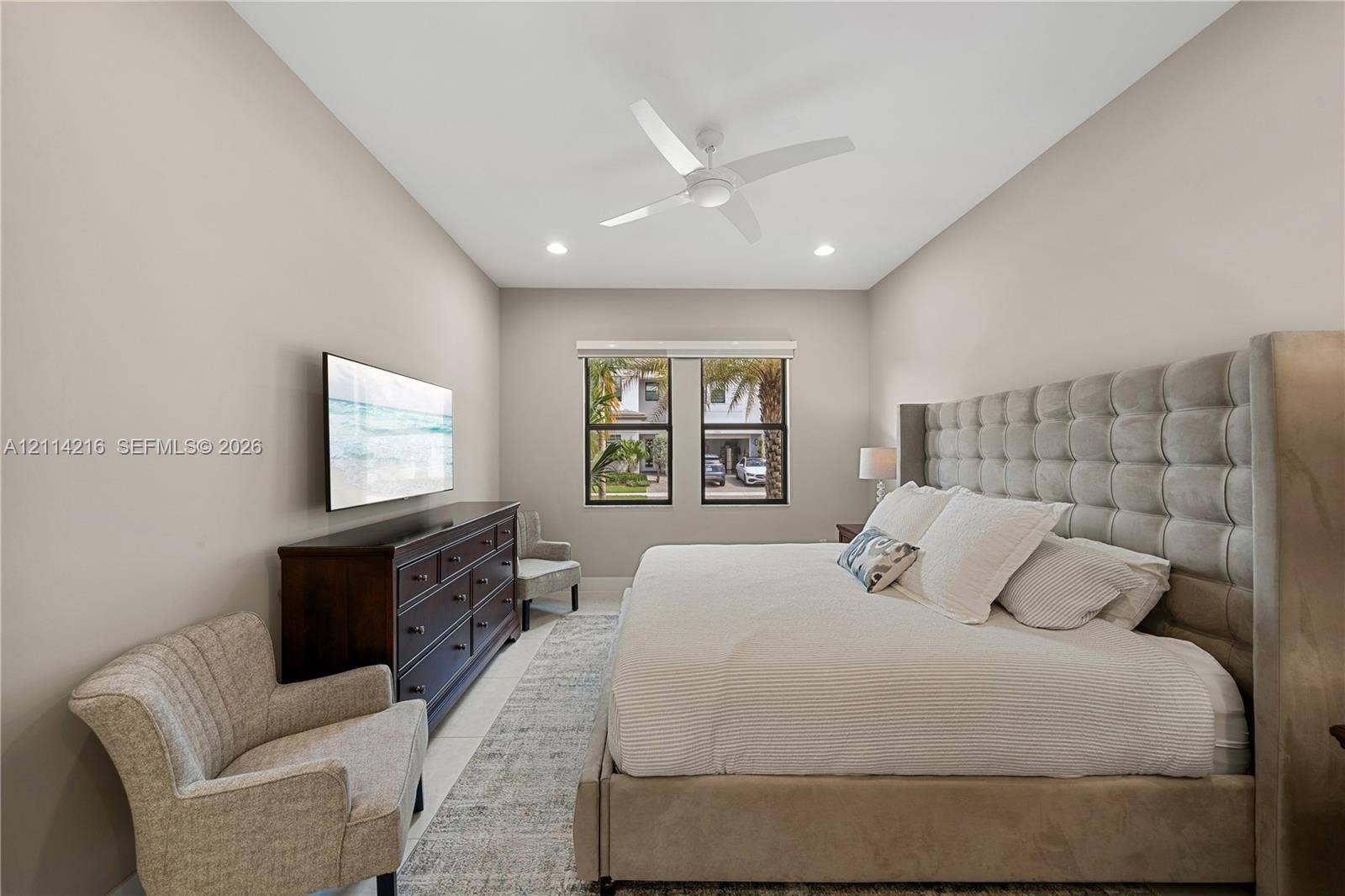 17085 Teton River Road, Boca Raton, FL 33496 Neutral wall tones featuring a high ceiling with recessed lighting and a ceiling fan, complemented by windows with dark framing