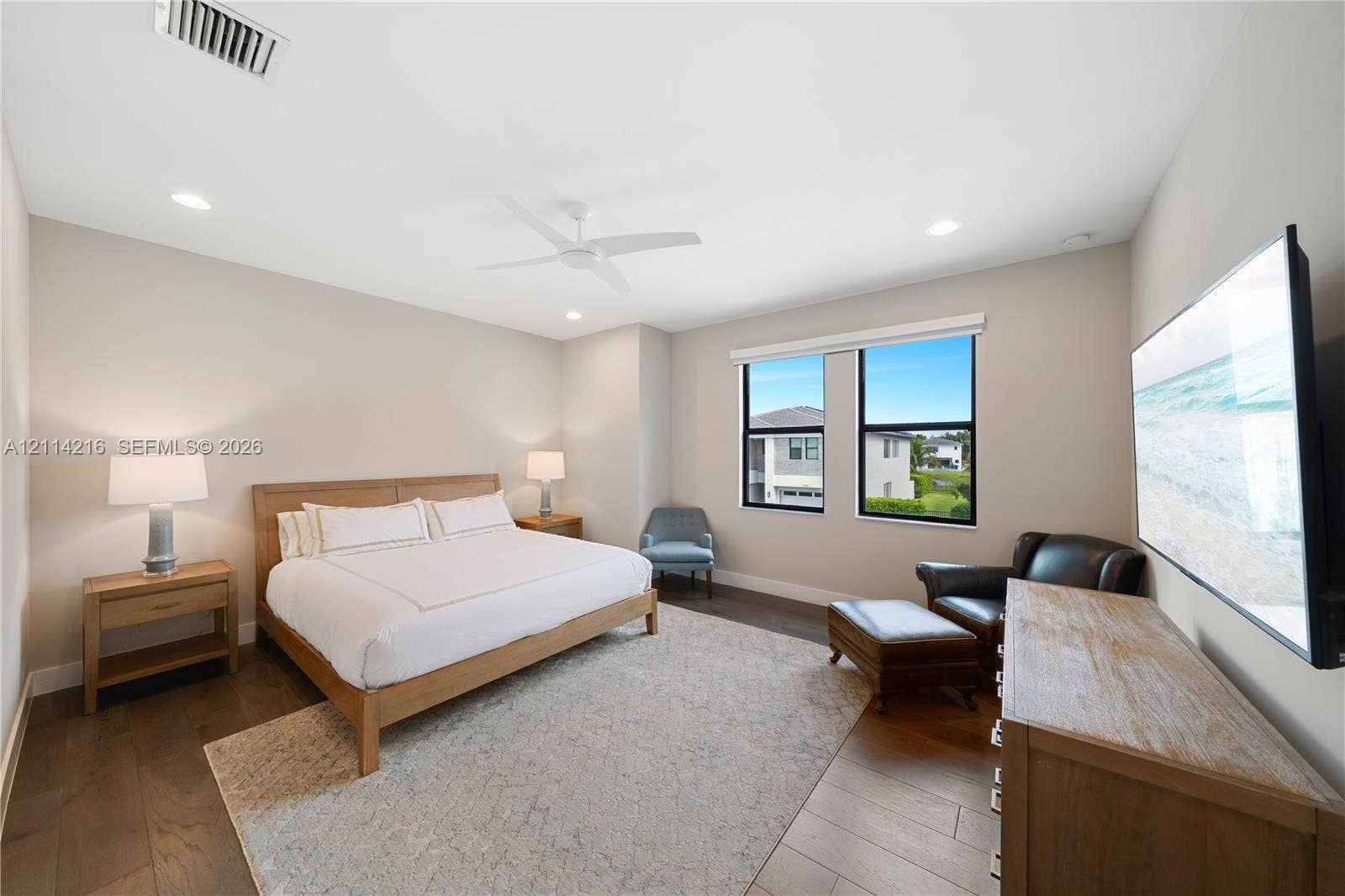 17085 Teton River Road, Boca Raton, FL 33496 Spacious room featuring wood-finish flooring, recessed lighting, a white ceiling fan, and large windows with black frames