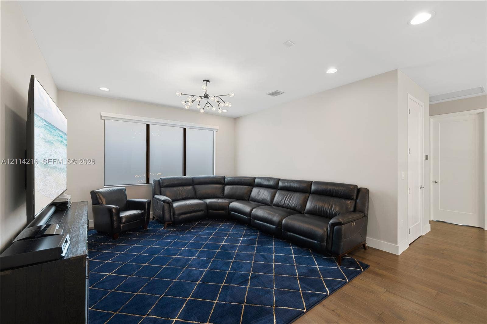 17085 Teton River Road, Boca Raton, FL 33496 Room featuring wood-finish flooring, recessed lighting, and a multi-arm modern chandelier