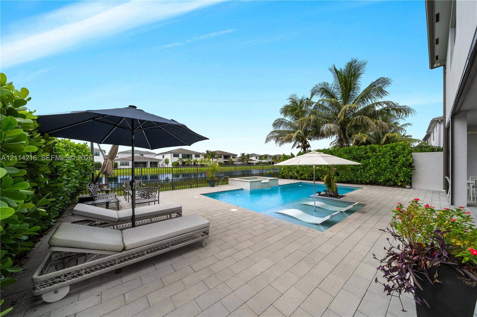 17085 Teton River Road, Boca Raton, FL 33496 Screened swimming pool and spa with stone paver decking, finished with perimeter landscaping and water frontage