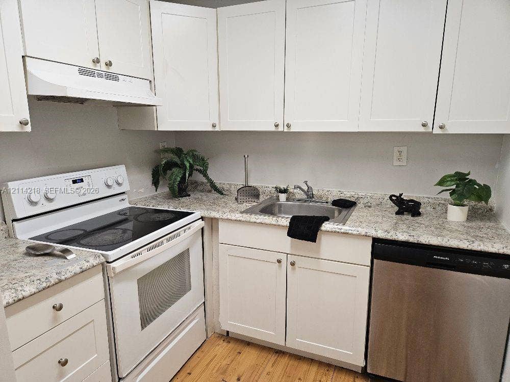 1116 Meadows Circle, #1116, Boynton Beach, Boynton Beach, FL 33436 Kitchen featuring white shaker-style cabinetry, stone-finish countertops, stainless steel undermount sink, integrated range, and stainless steel dishwasher