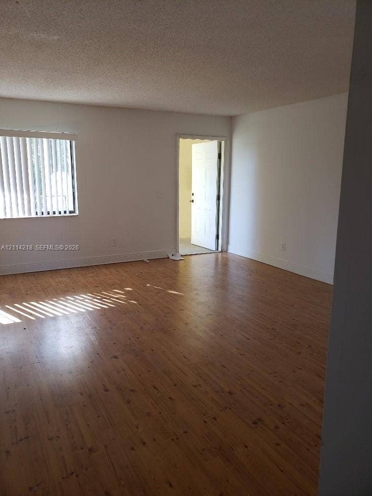 1116 Meadows Circle, #1116, Boynton Beach, Boynton Beach, FL 33436 Wood-finish flooring, neutral walls, and window with vertical blinds