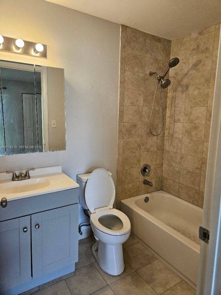 1116 Meadows Circle, #1116, Boynton Beach, Boynton Beach, FL 33436 Bathroom featuring a vanity with an integrated sink, rectangular medicine cabinet, wall-mounted light fixture, and shower-tub combination with stone-finish tile surround and handheld shower head