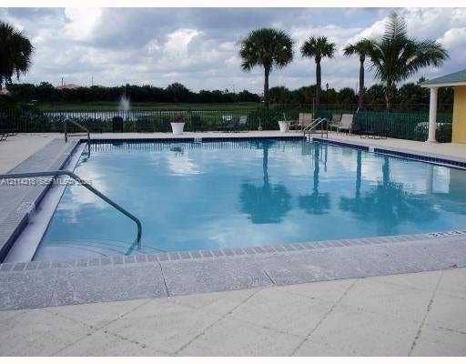 1116 Meadows Circle, #1116, Boynton Beach, Boynton Beach, FL 33436 Swimming pool with a paved deck, metal railings, and perimeter fencing
