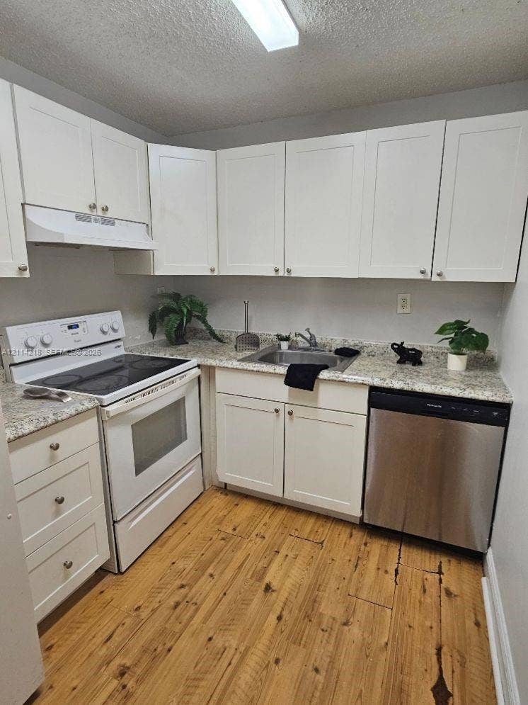 1116 Meadows Circle, #1116, Boynton Beach, Boynton Beach, FL 33436 Kitchen featuring white shaker-style cabinetry, stone-finish countertops, wood-finish flooring, and stainless steel dishwasher