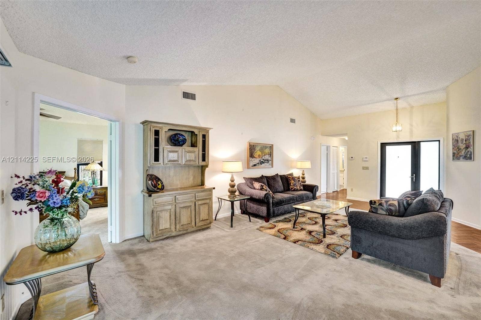 5741 SW 88th Terrace, Cooper City, FL 33328 Vaulted ceilings, built-in wooden cabinetry, and glass-paned exterior door