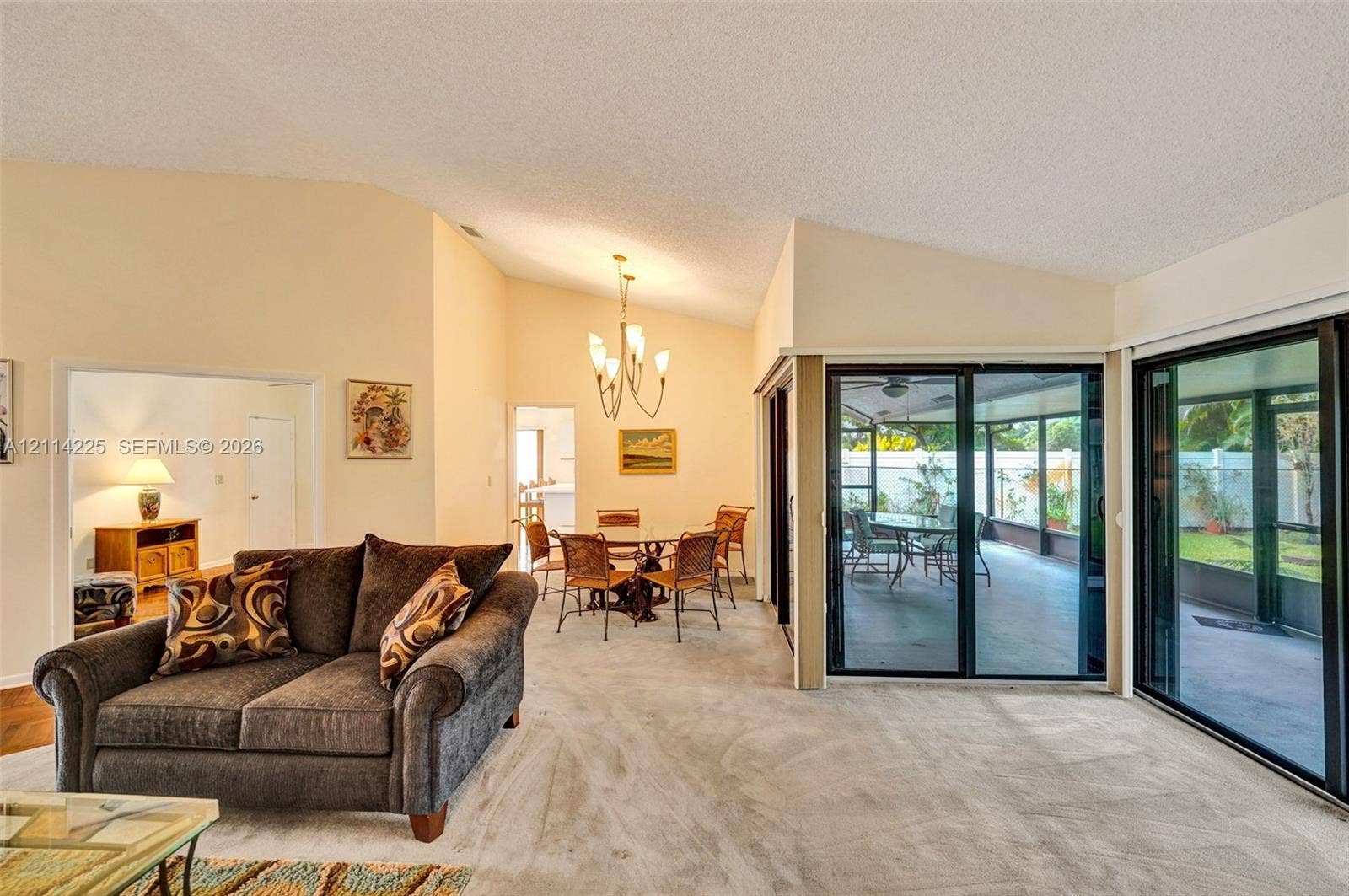 5741 SW 88th Terrace, Cooper City, FL 33328 Vaulted ceilings with recessed lighting, multi-panel sliding glass doors, and carpeted flooring
