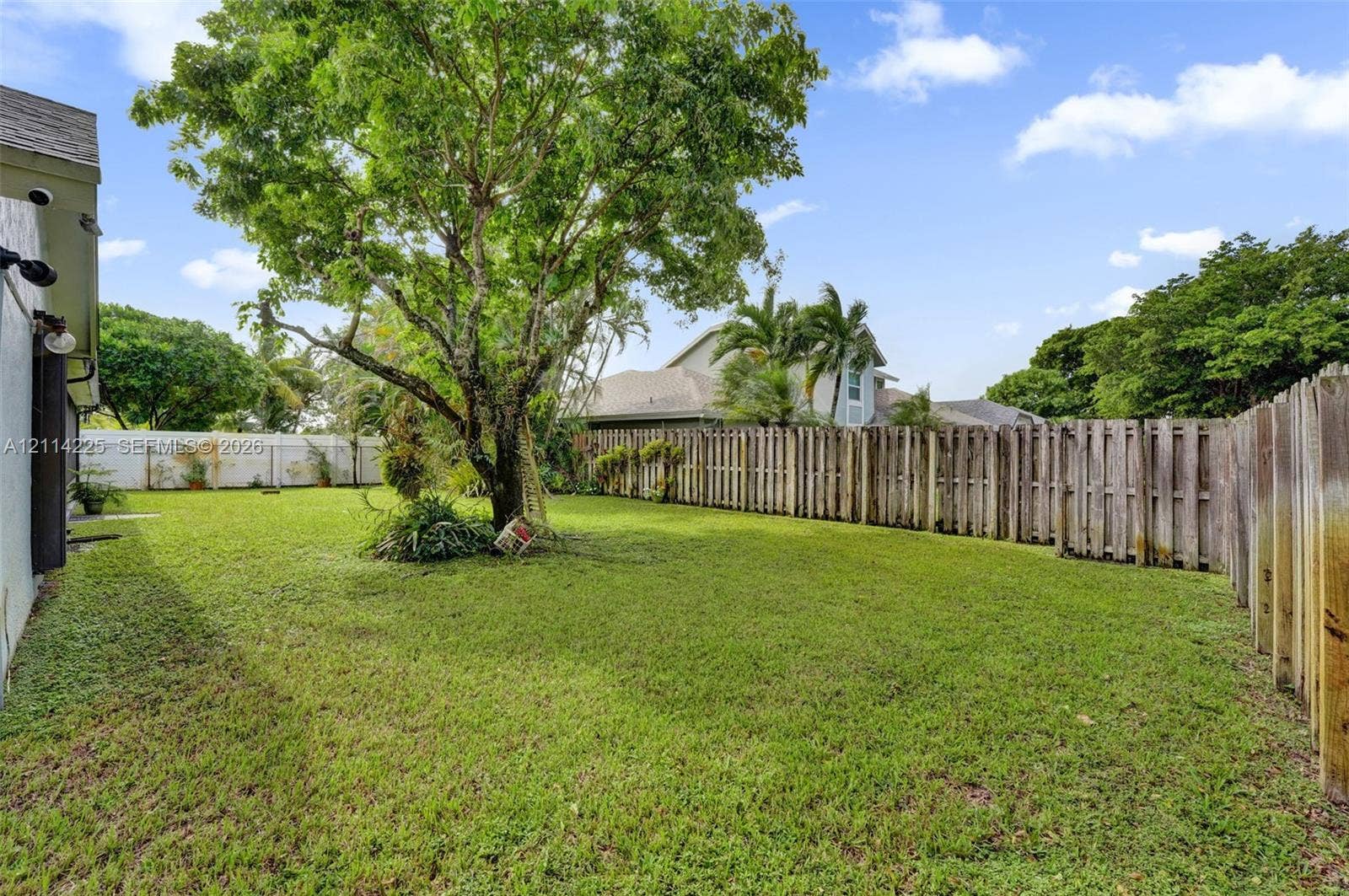 5741 SW 88th Terrace, Cooper City, FL 33328 Expansive backyard featuring a fenced perimeter, mature tree, and open green space